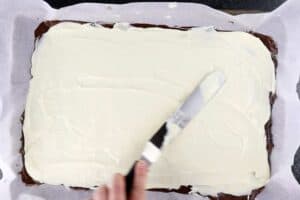 spreading white chocolate over milk chocolate layer