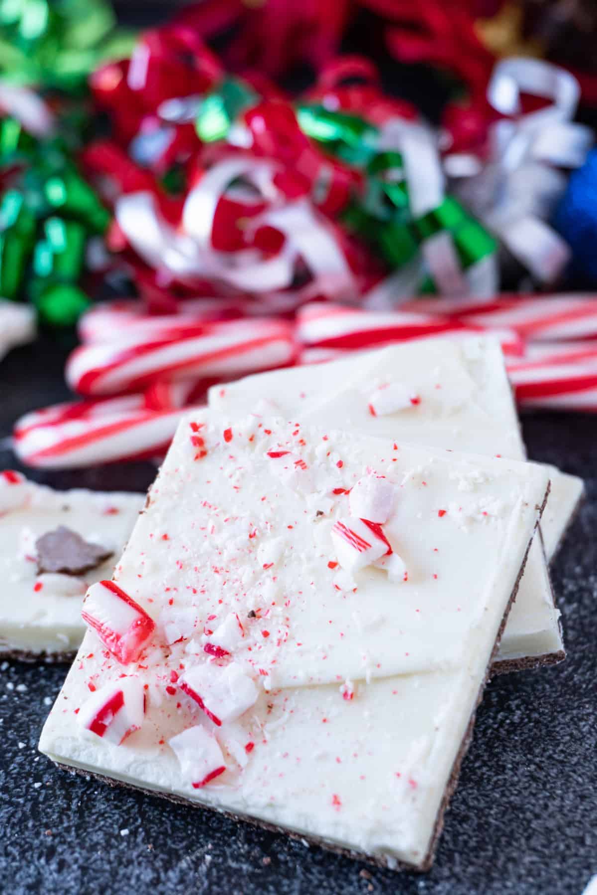 This simple homemade peppermint bark recipe will be a hit at any holiday gathering! White chocolate, chocolate, and peppermint – the perfect dessert! peppermint bark stacked