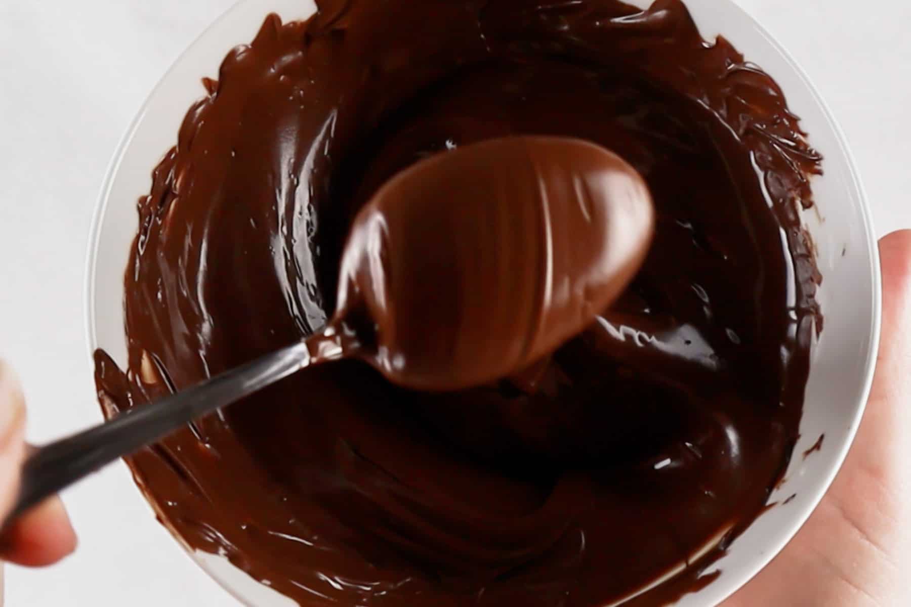 Melted chocolate in white bowl.