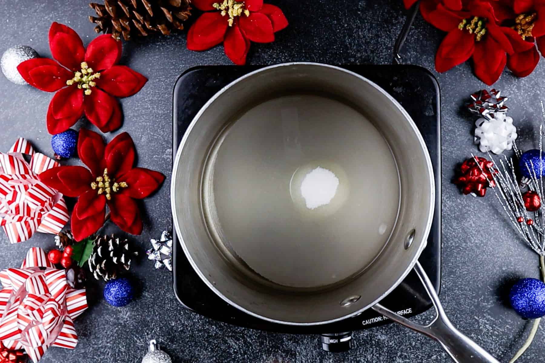 dissolving sugar in water in  a saucepan.