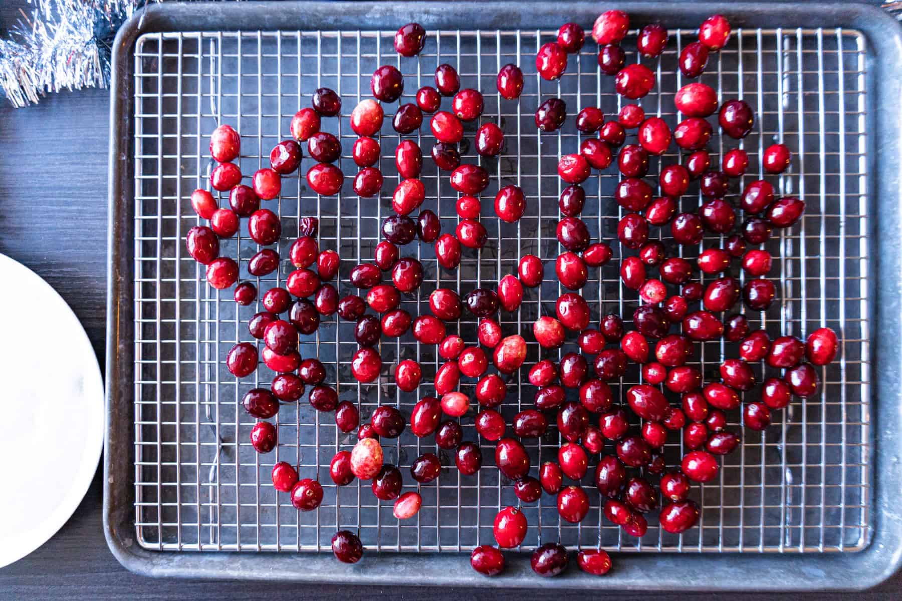cranberries on a wire cooling rack, drying.