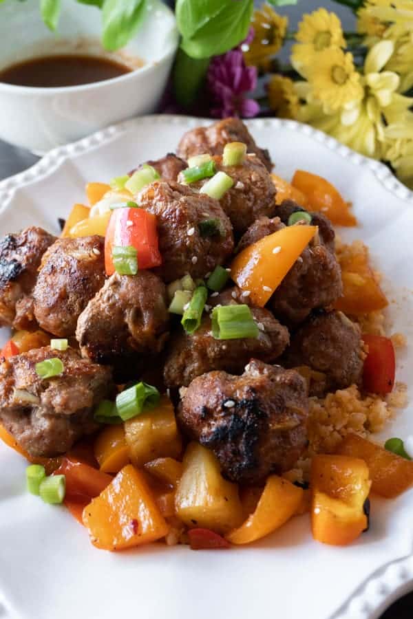 Sweet and Sour Meat Balls, a delicious meatball recipe that will have you making these over and over again! Dairy, Soy, and Gluten free you won’t want to miss this tasty healthy dinner! #meatballs #paleo #paleomeatballs #sweetandsour #glutenfree #dairyfree #soyfree #dinner #atablefullofjoy #asian #pork #baked