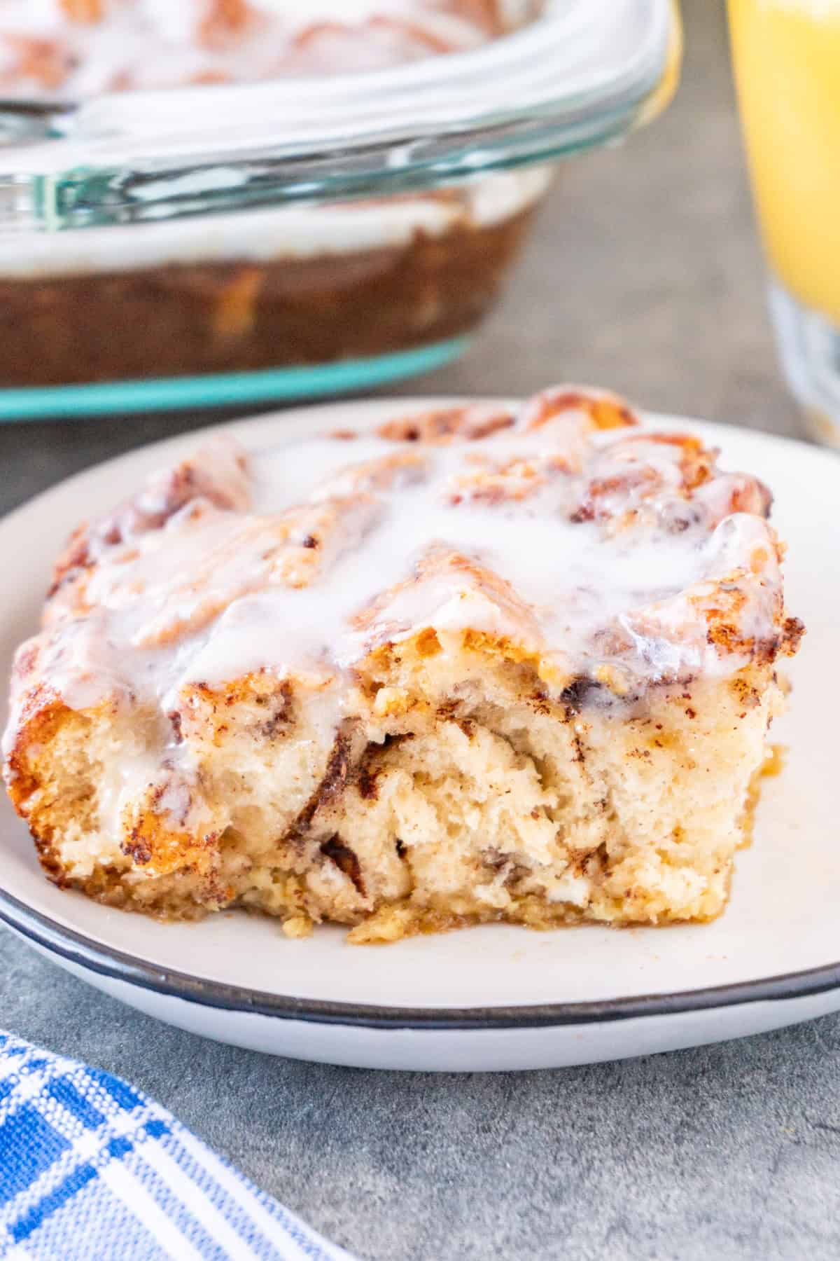 Slice of Cinnamon Roll French Toast on a white plate.