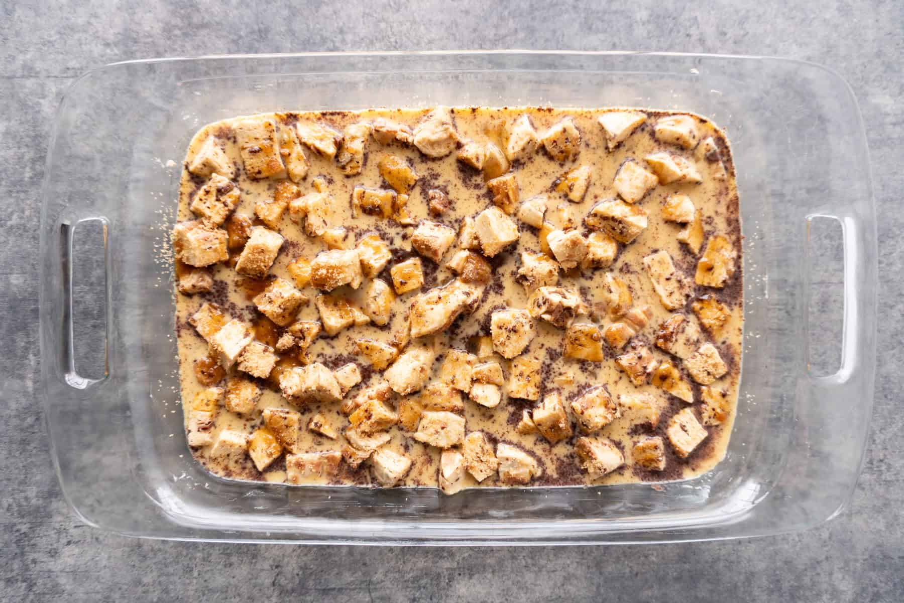 French Toast Casserole is assembled in a casserole dish before baking.