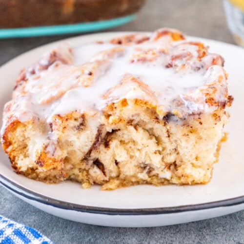 Slice of Cinnamon Roll French Toast on a white plate, featured image.