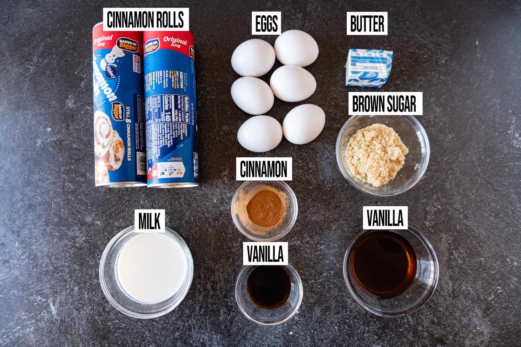 Cinnamon Roll French Toast Ingredients laid out, in individual bowls, and labeled.