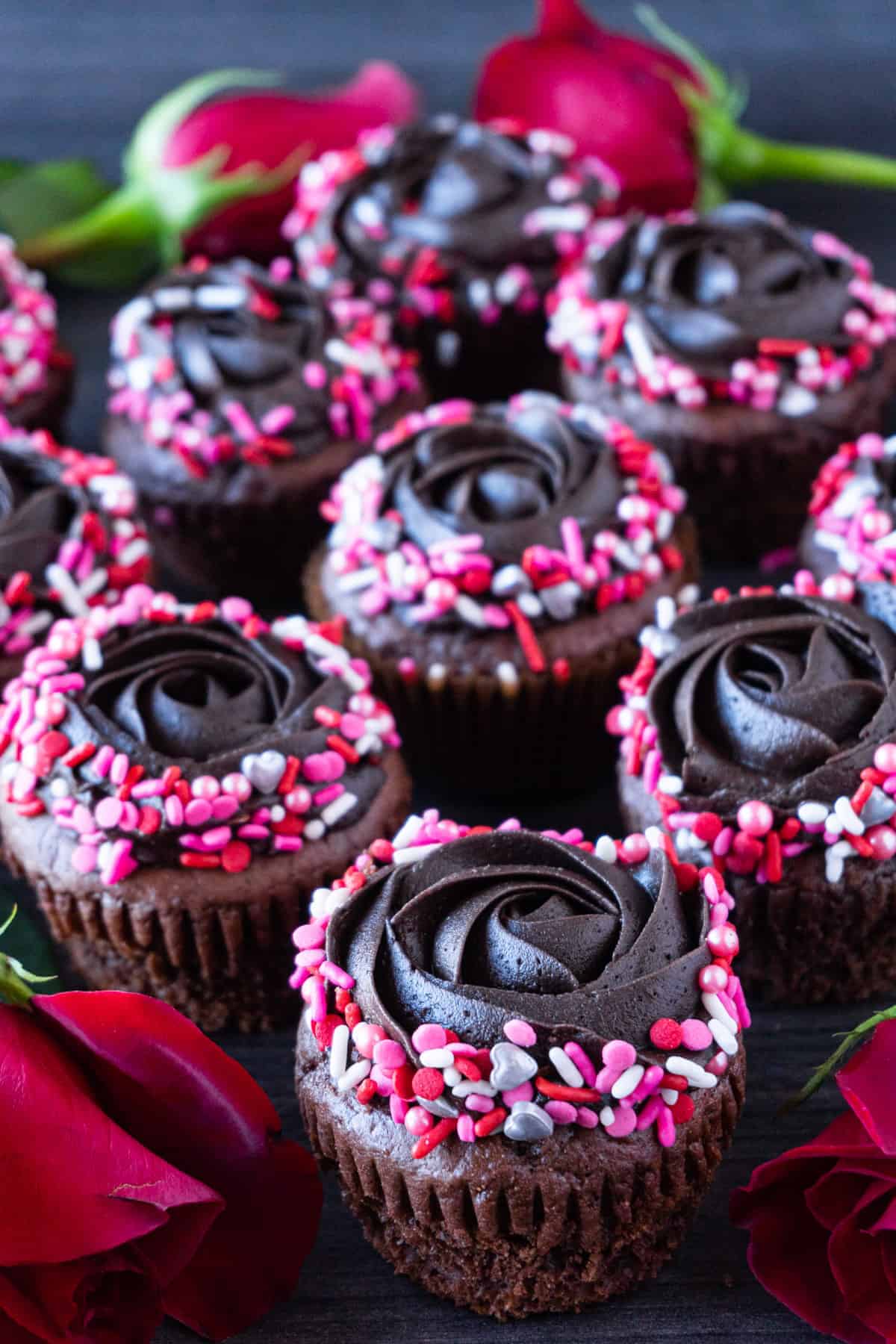 valentine's day cupcakes close together with roses