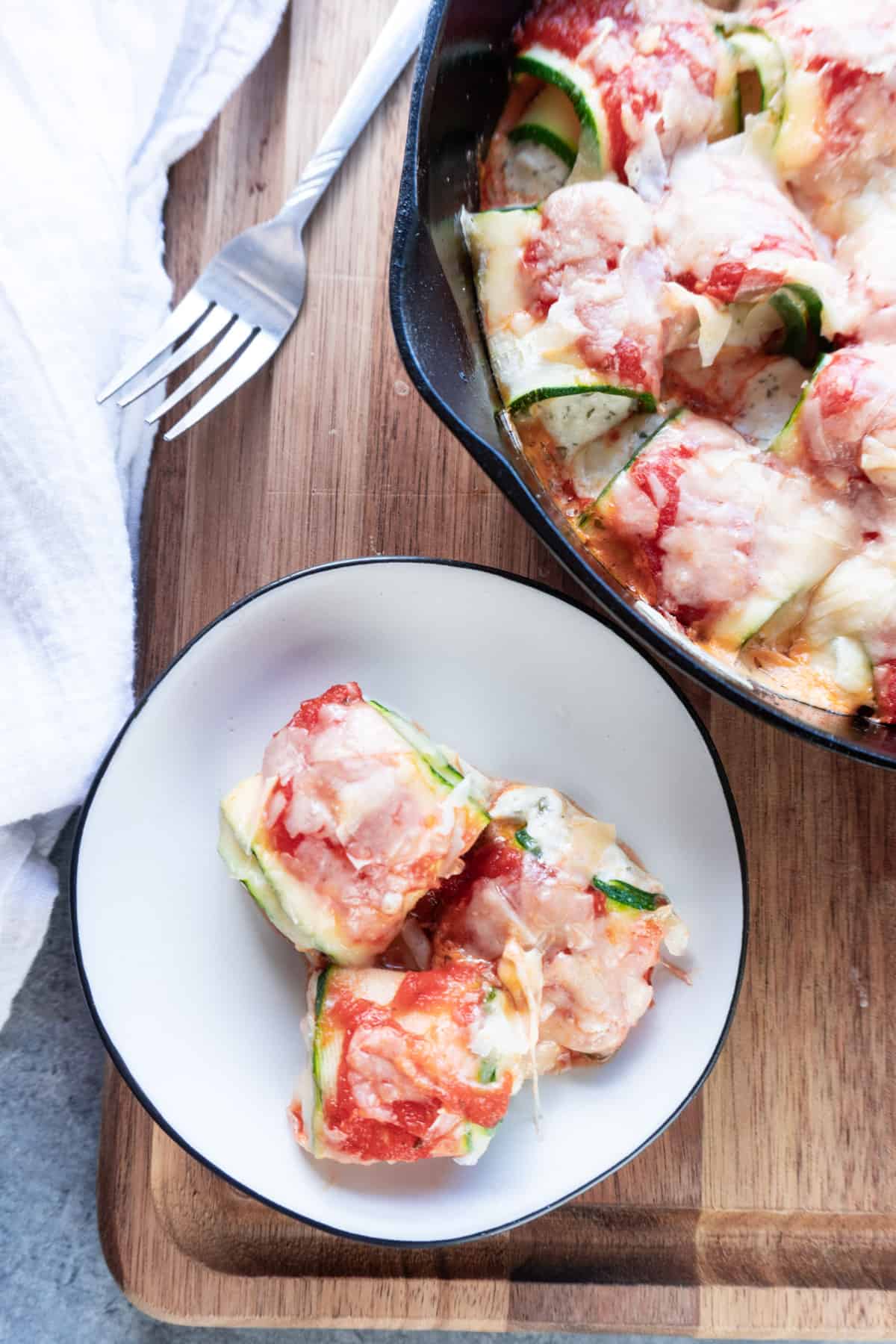 zucchini appetizer on plate with baking dish near