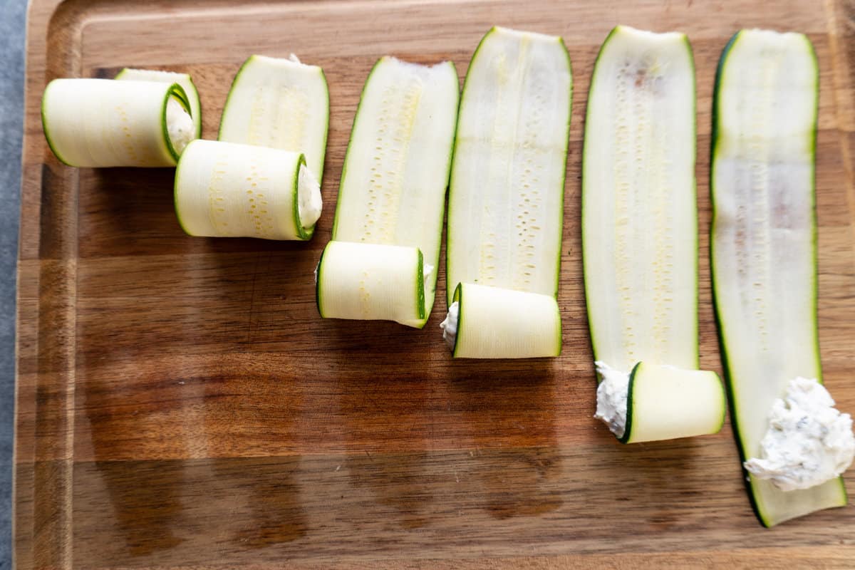 progression of slices of zucchini being rolled up