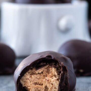 Chocolate Peanut Butter Balls, an easy and delicious treat that is the perfect balance of chocolate and peanut butter! #peanutbutter #3ingredients #nobake #atablefullofjoy #easter #peanutbutterballs #easy