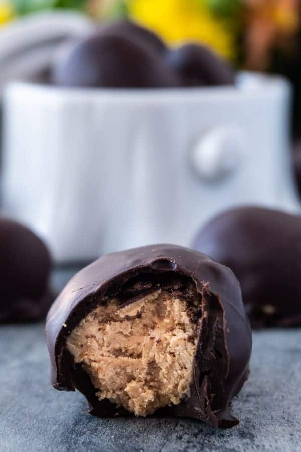 Chocolate Peanut Butter Balls, an easy and delicious treat that is the perfect balance of chocolate and peanut butter! #peanutbutter #3ingredients #nobake #atablefullofjoy #easter #peanutbutterballs #easy