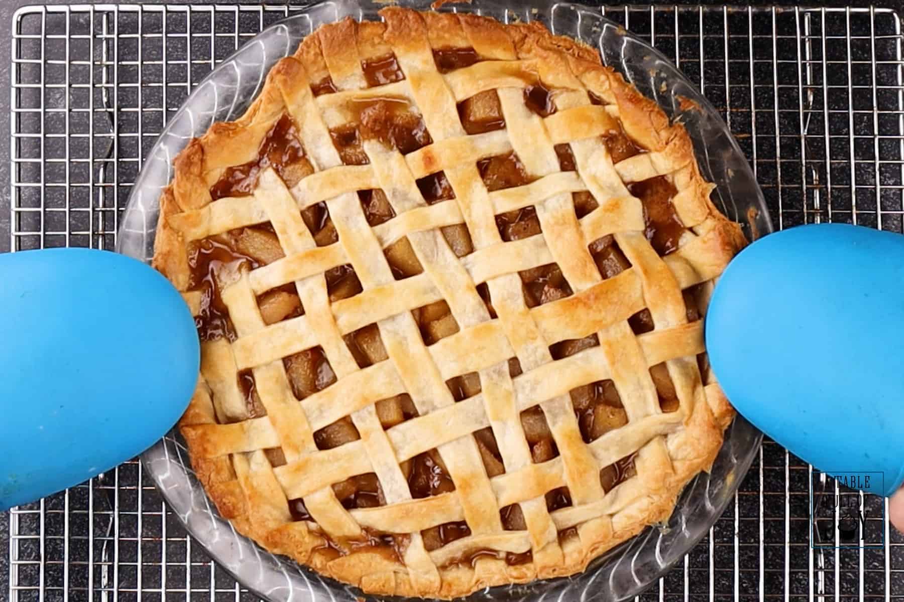 Caramel Pear Pie cooked with golden crust resting on a cooling rack.