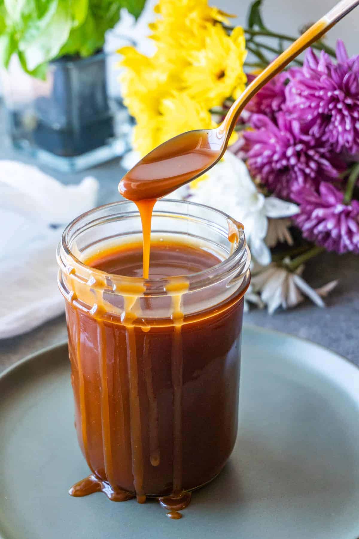 Caramel dripping over side of jar