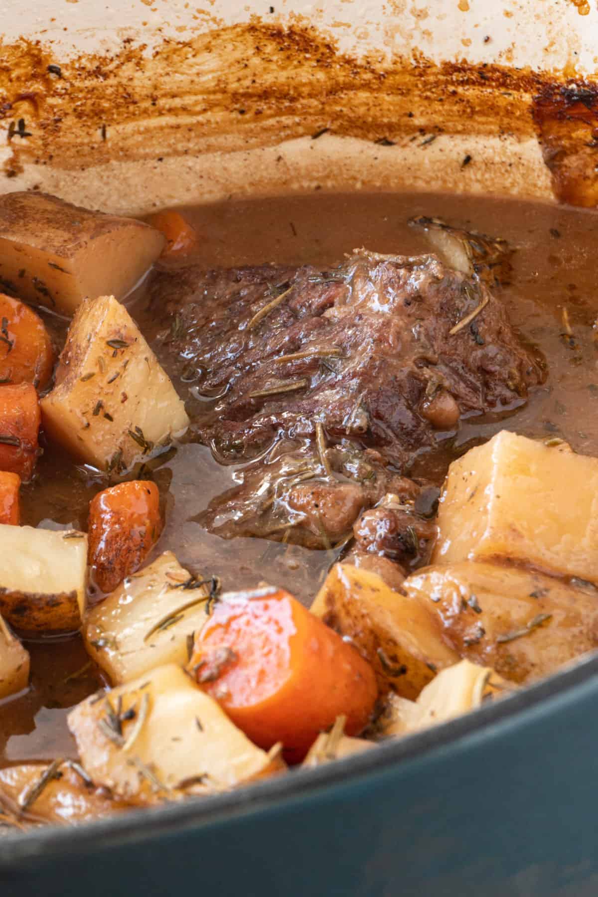 close up of meat in dutch oven