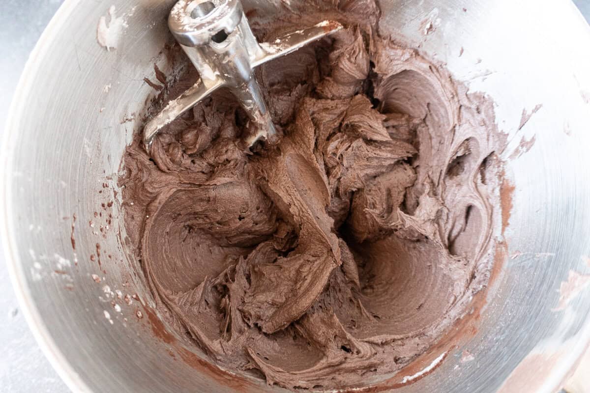 chocolate fudge frosting mixed in metal bowl.