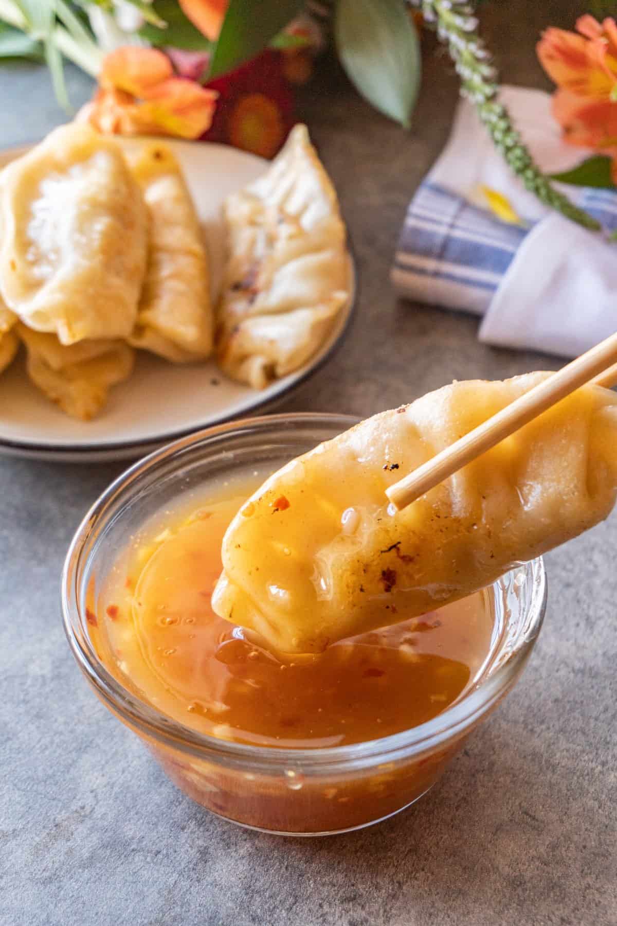 gyoza dipped into sauce.