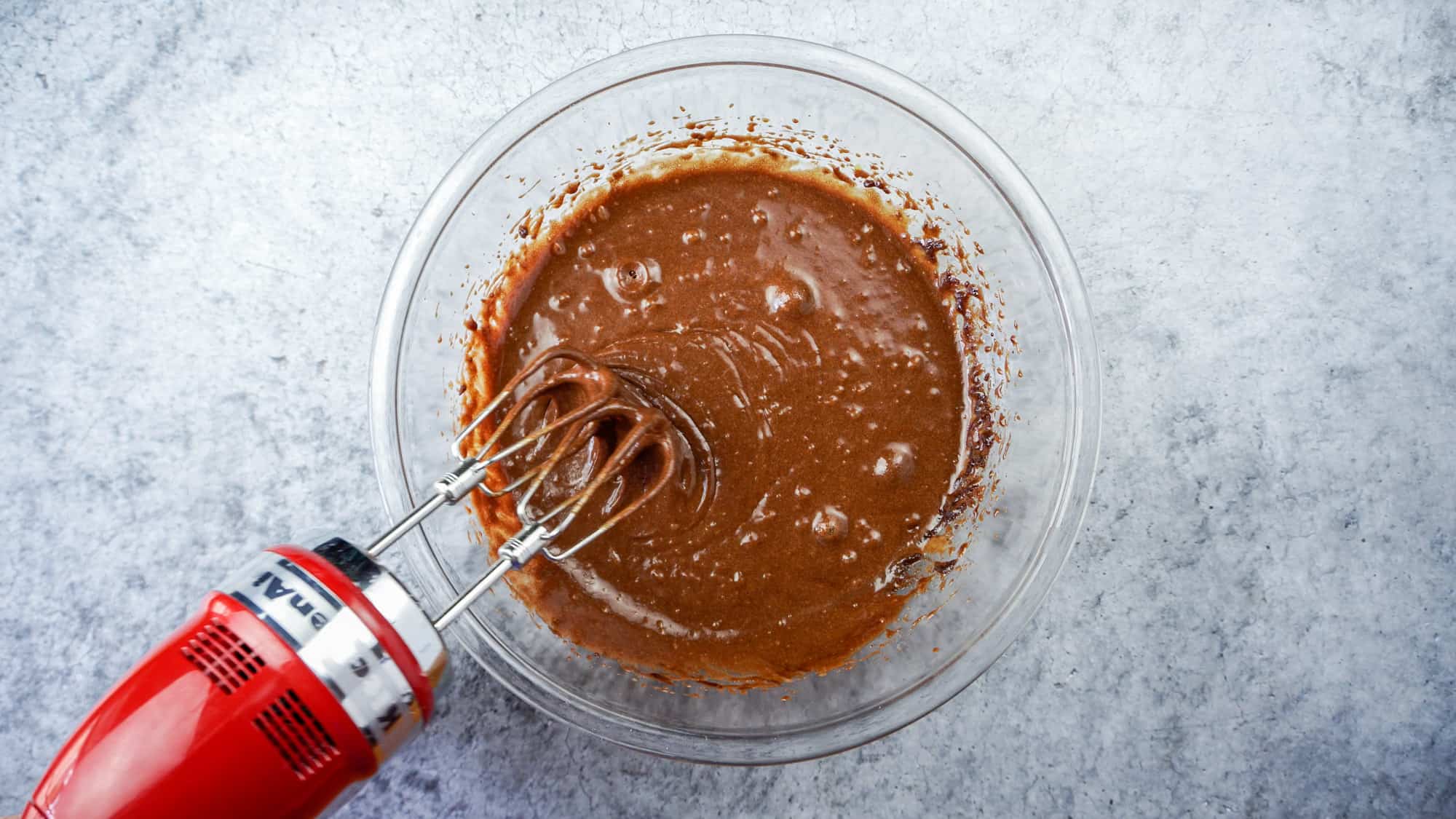 mixing in eggs to sugar mixture