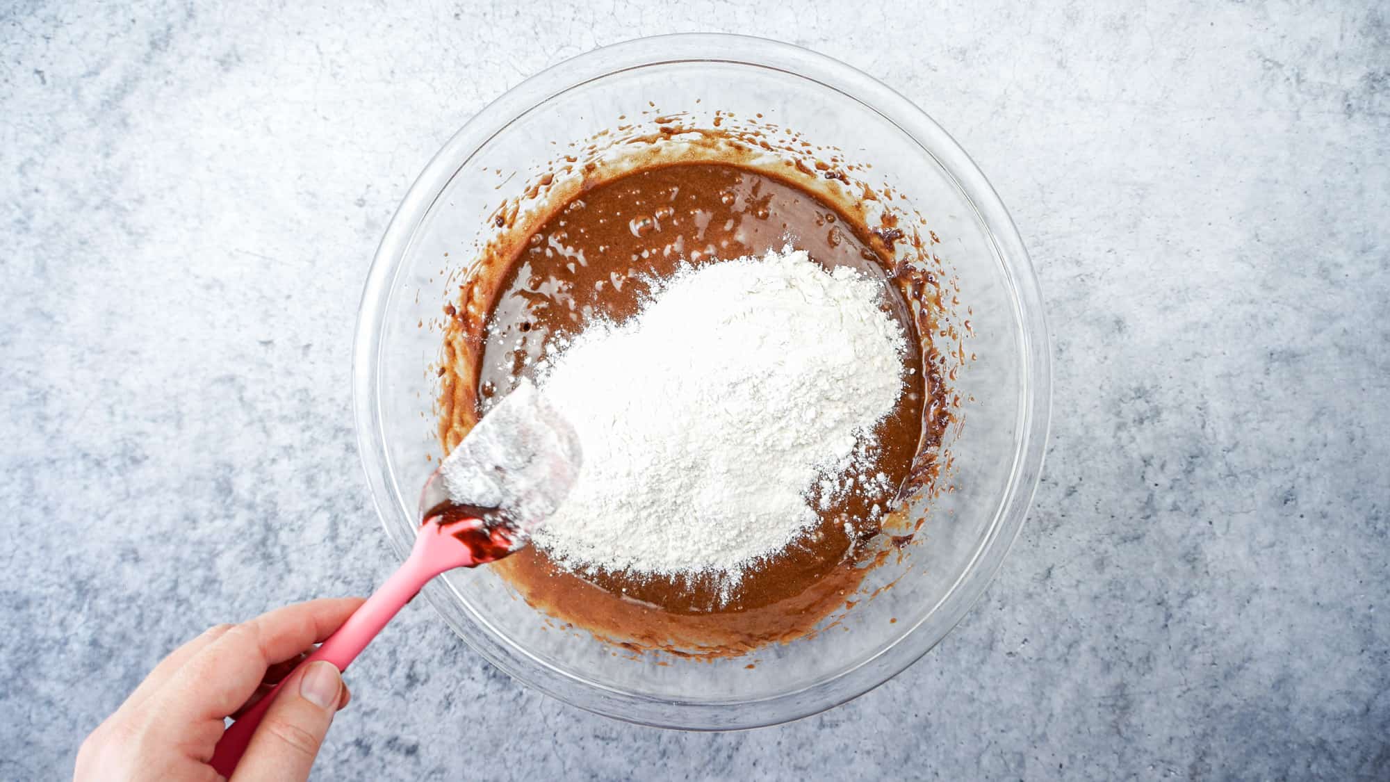 adding flour into brownie batter