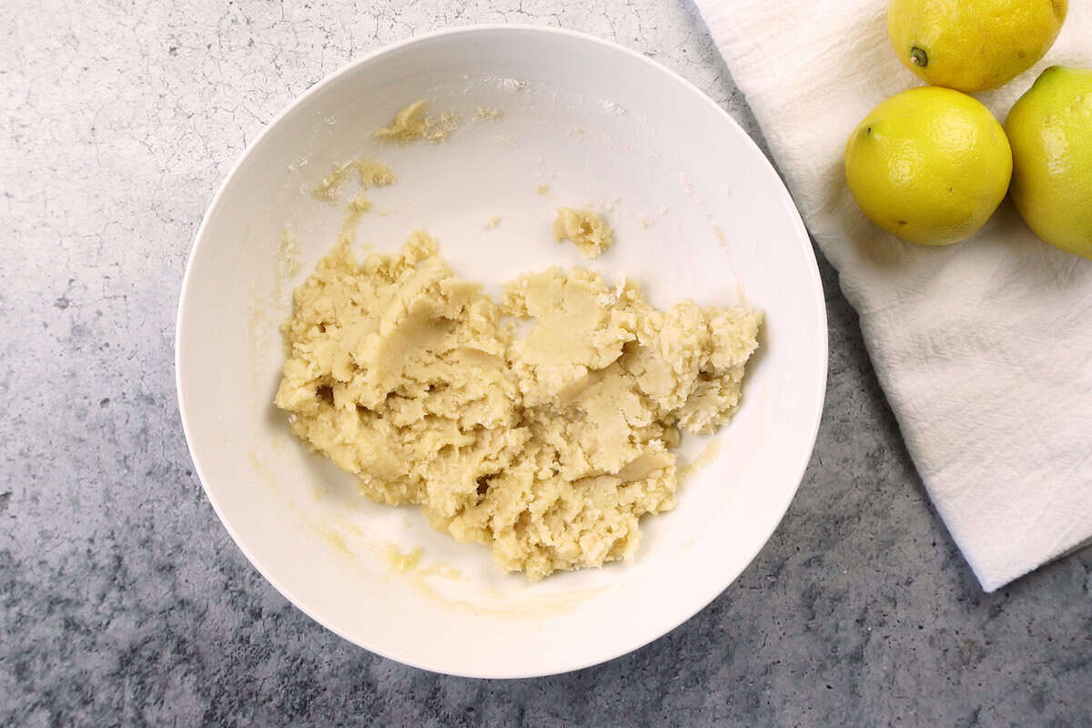 shortbread crust mixed in white whole, next to lemons.