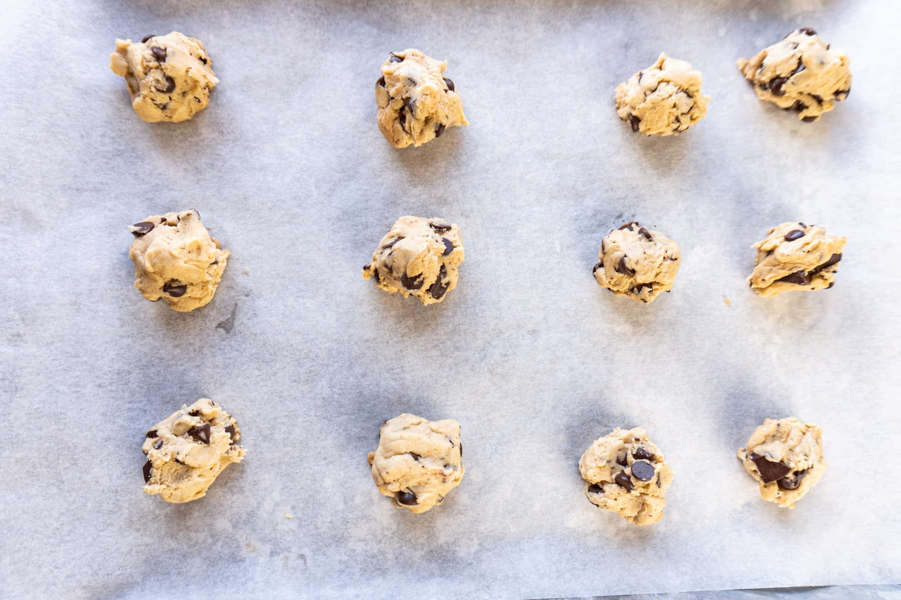 cookie dough balls on baking sheet