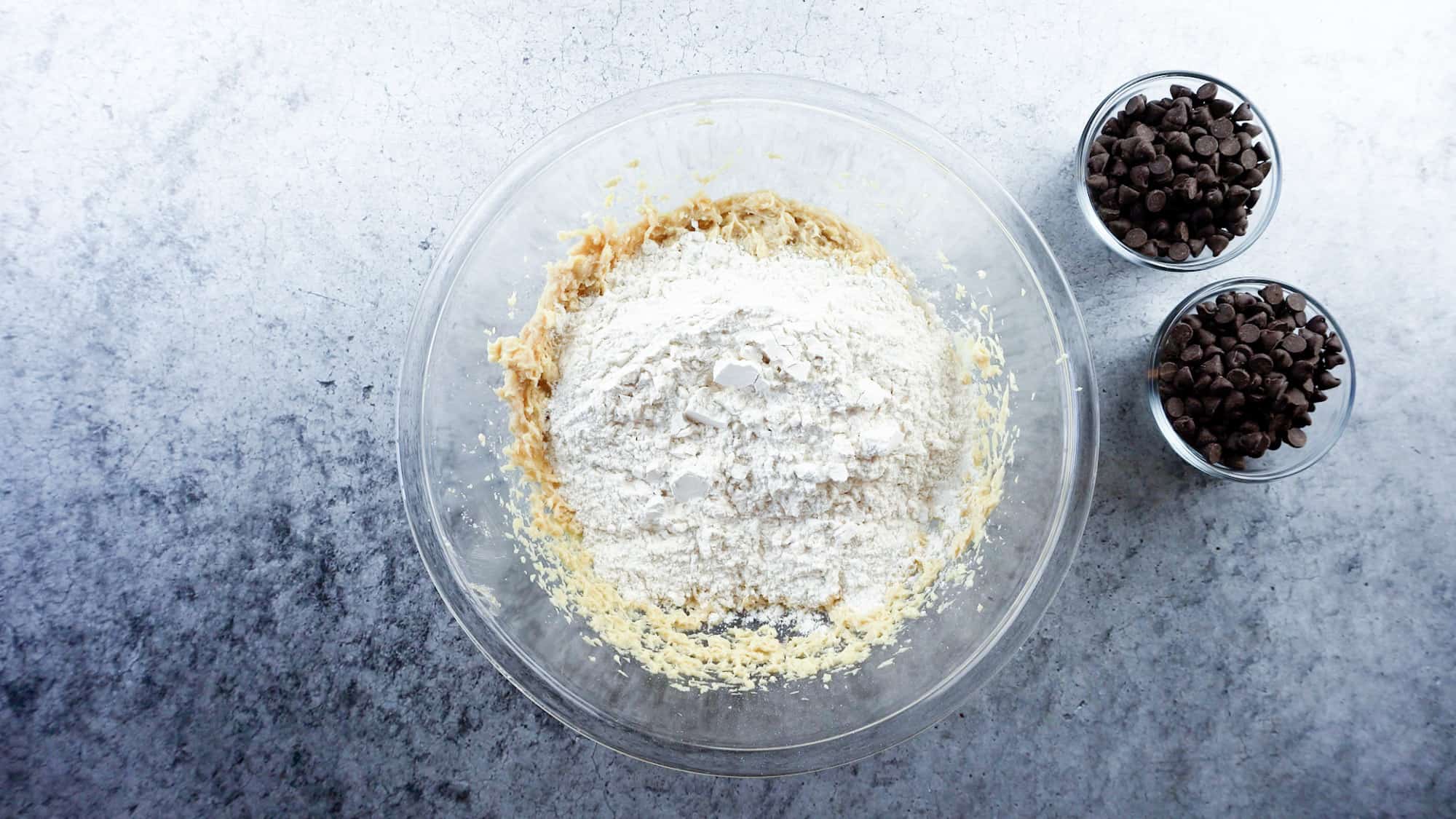 adding flour mixture to dough