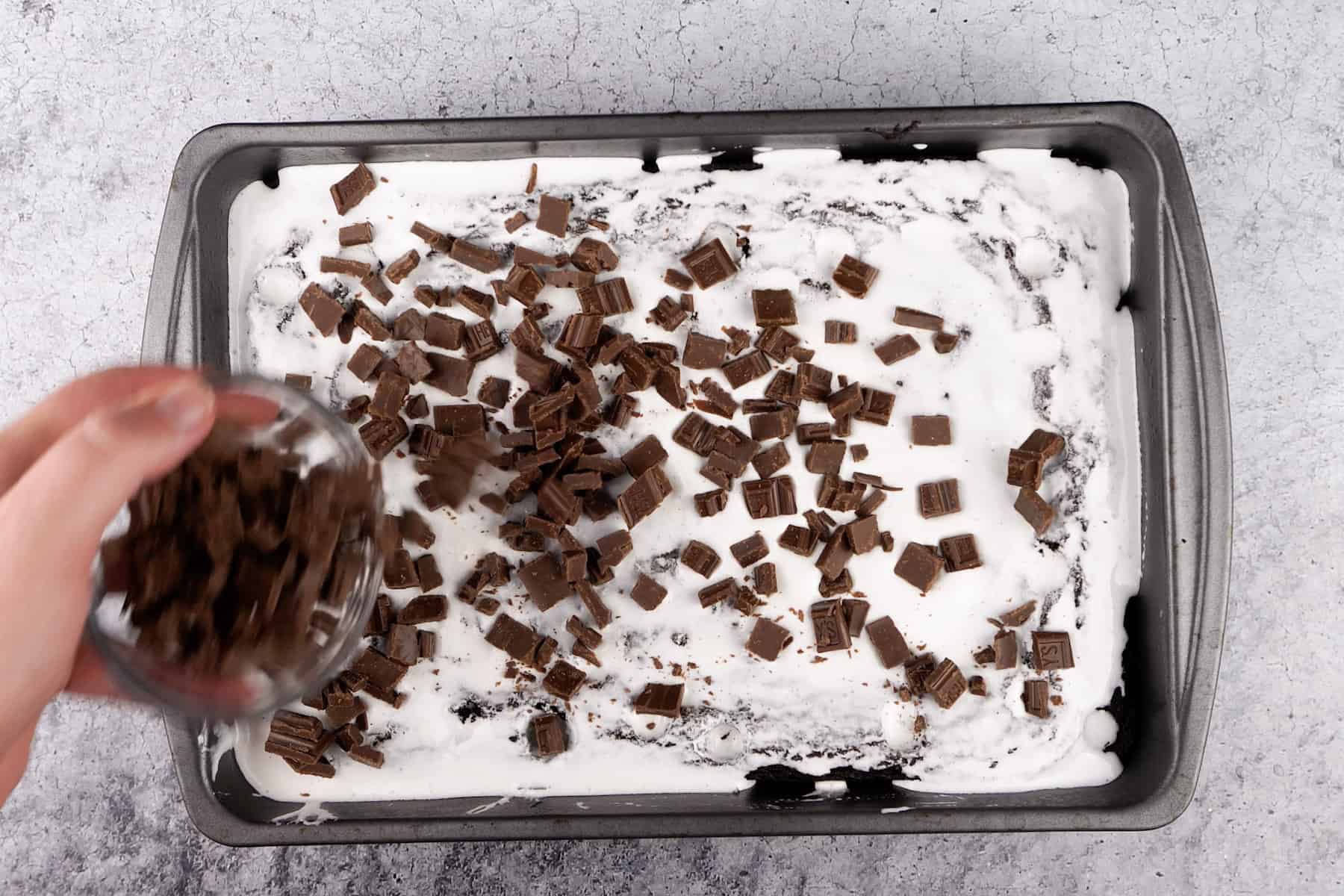 adding chocolate pieces to brownies