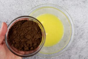 adding cocoa powder to melted butter