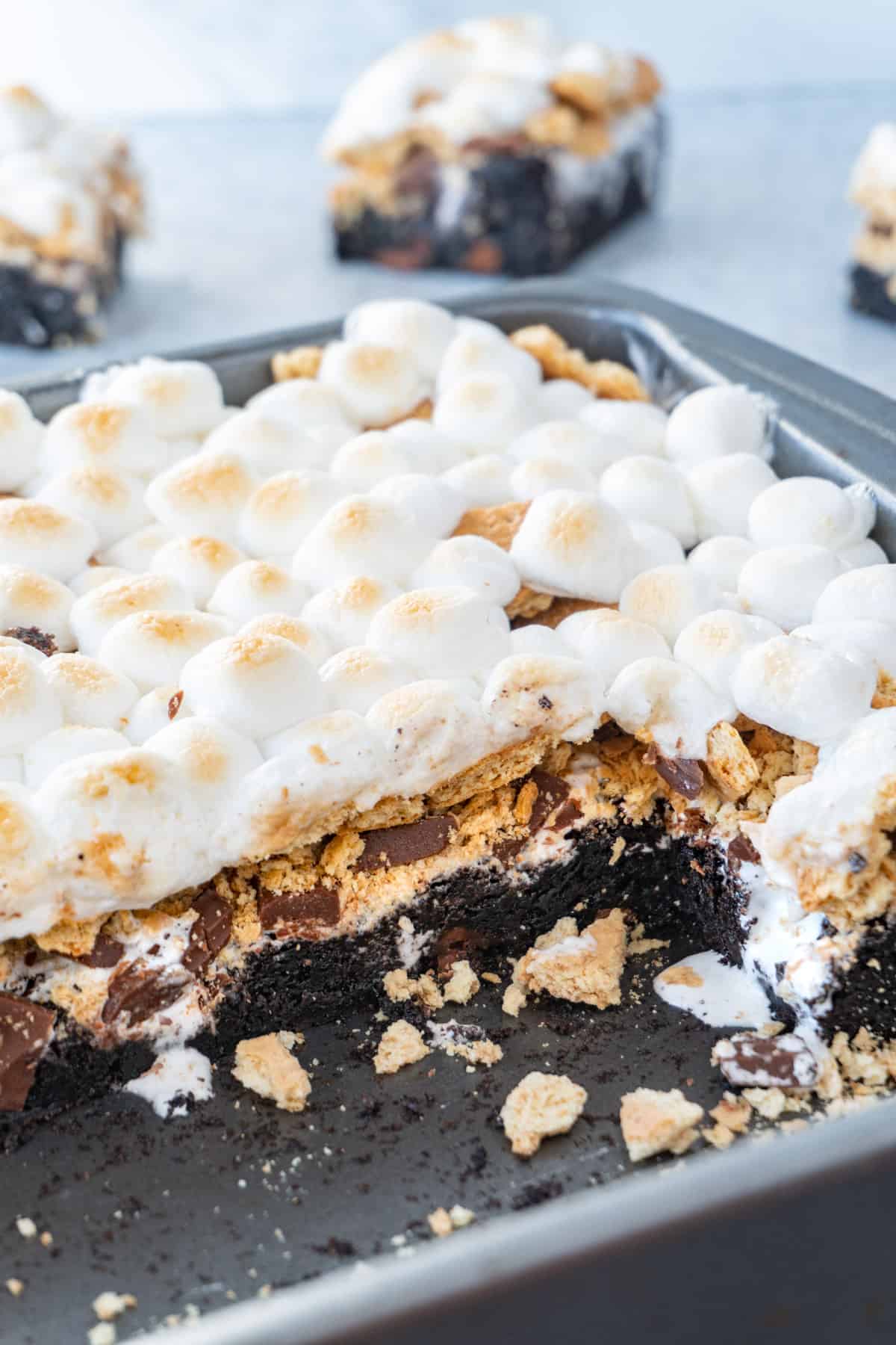 pan of s'more brownies showing layers of brownie, chocolate, marshmallow