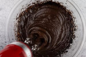 mixing in eggs to brownie batter