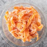 candied orange peels in a small glass bowl featured image.