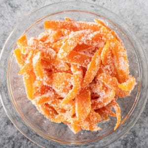 candied orange peels in a small glass bowl featured image.
