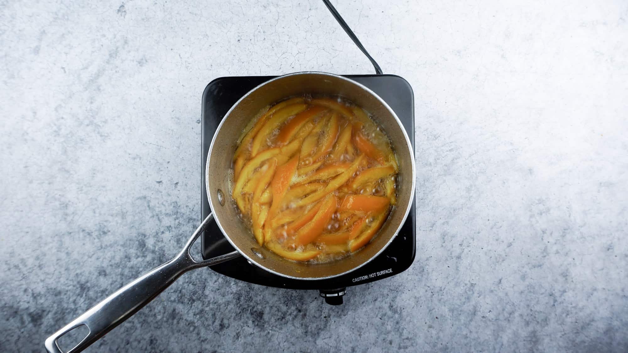 boiling orange peels in sugar water