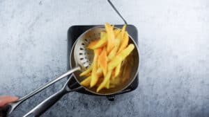 taking candied orange peels out of simple syrup