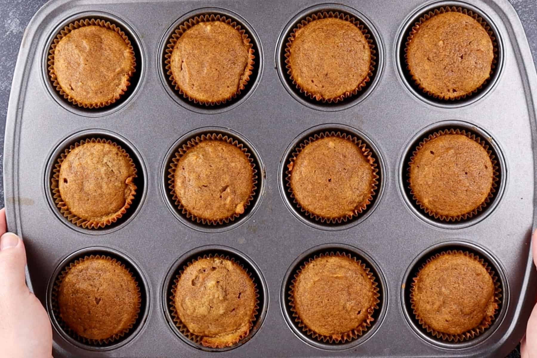 pumpkin cupcakes baked in cupcake tin.
