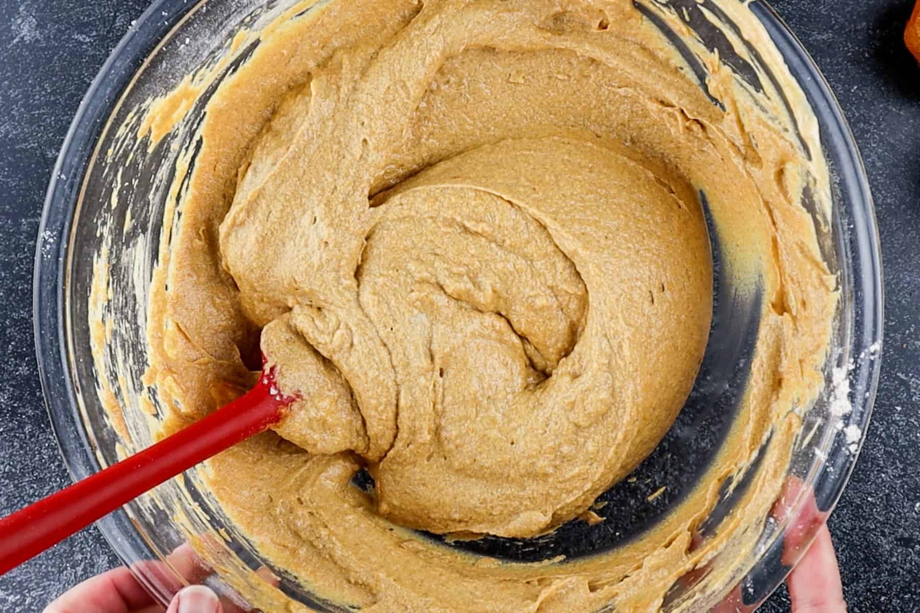 pumpkin cupcake batter with all ingredients added. Mixed in glass bowl.