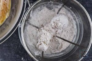 Sift each piece in a strainer before frying