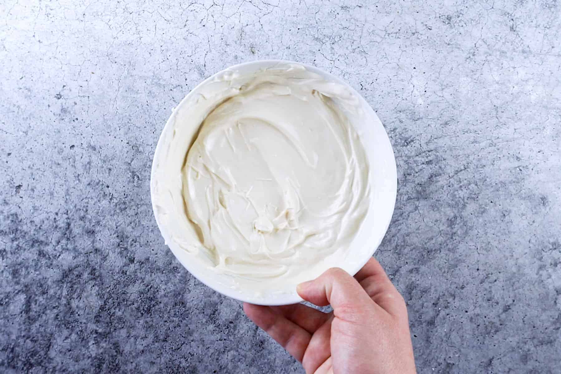 melted white candy melts in white bowl.