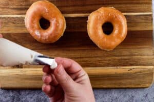 adding eyes to mummy donuts