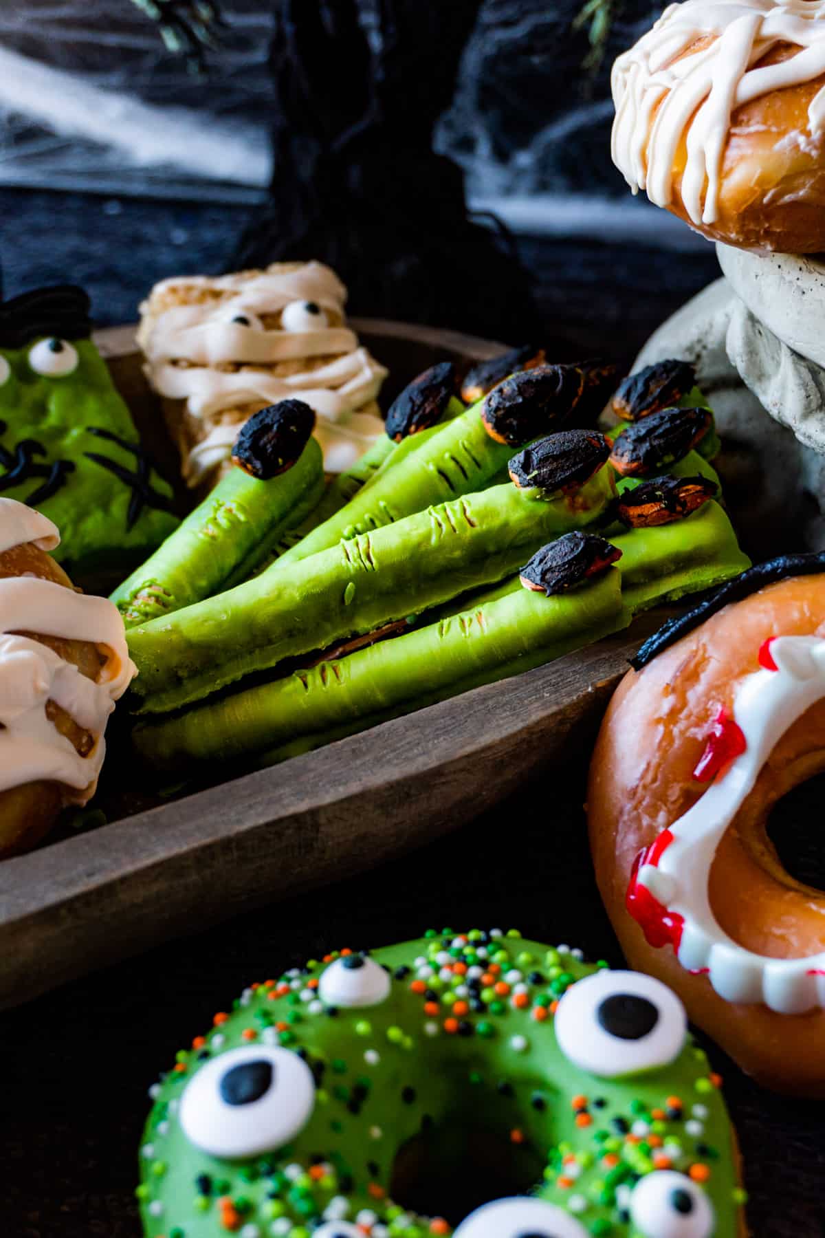 witches fingers in a snack board with other halloween snacks