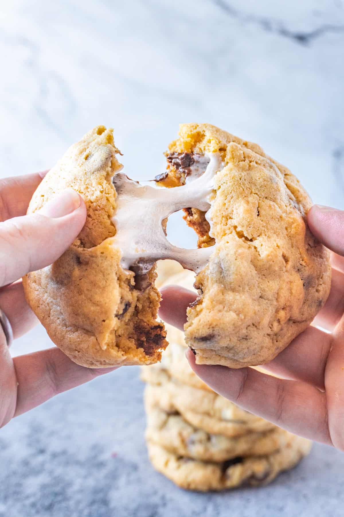 pulling apart a marshmallow stuffed cookie