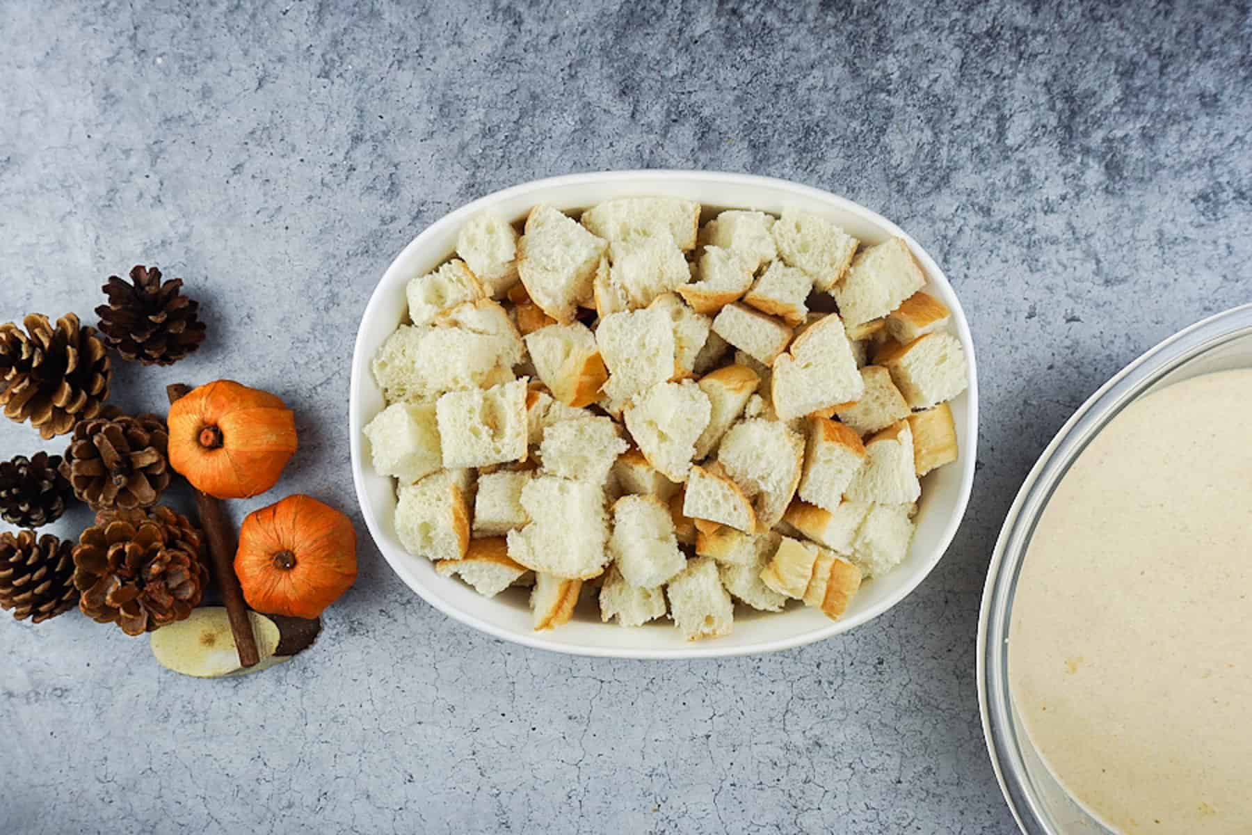 Cubed sourdough bread in white dish.