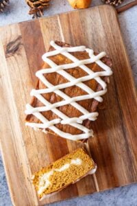Pumpkin Bread on cutting board with frosting on top
