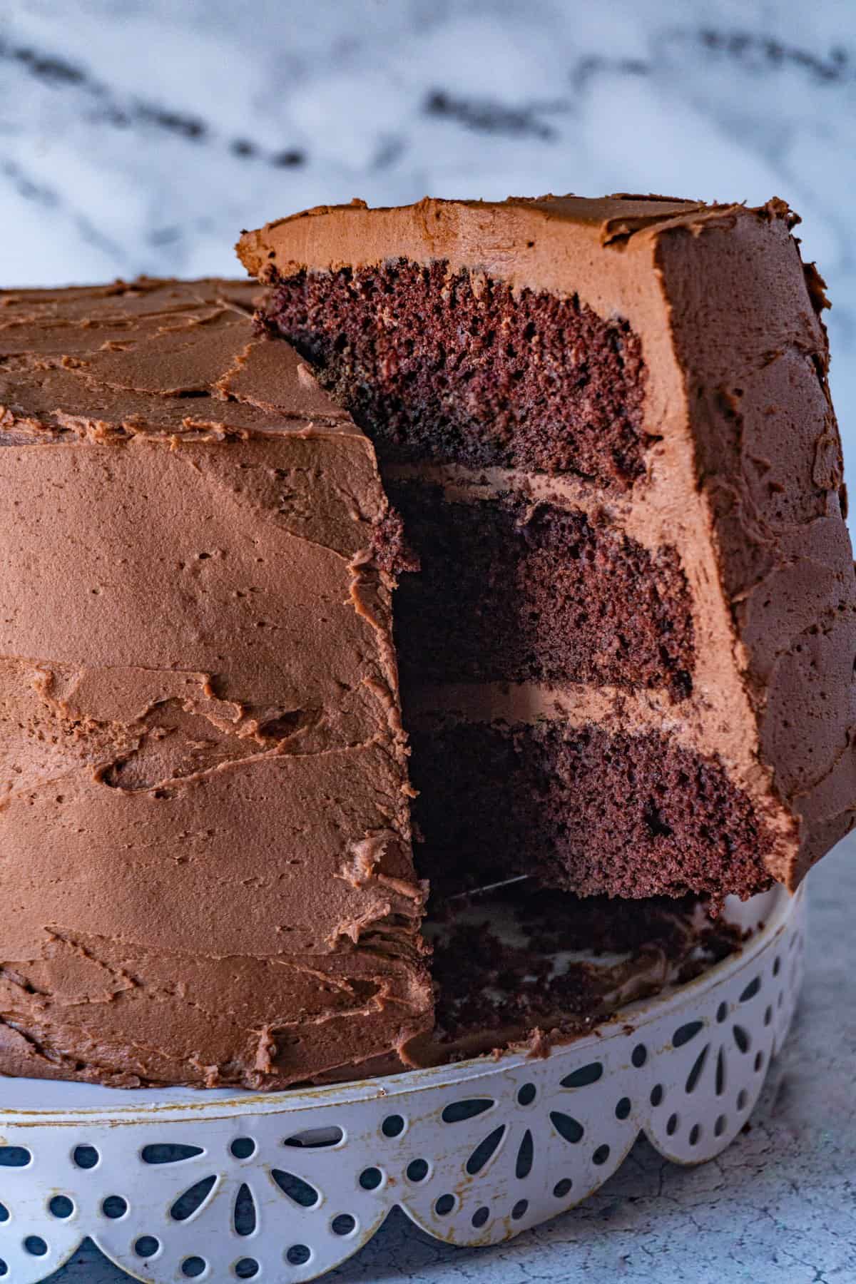taking a slice of buttermilk chocolate cake from cake