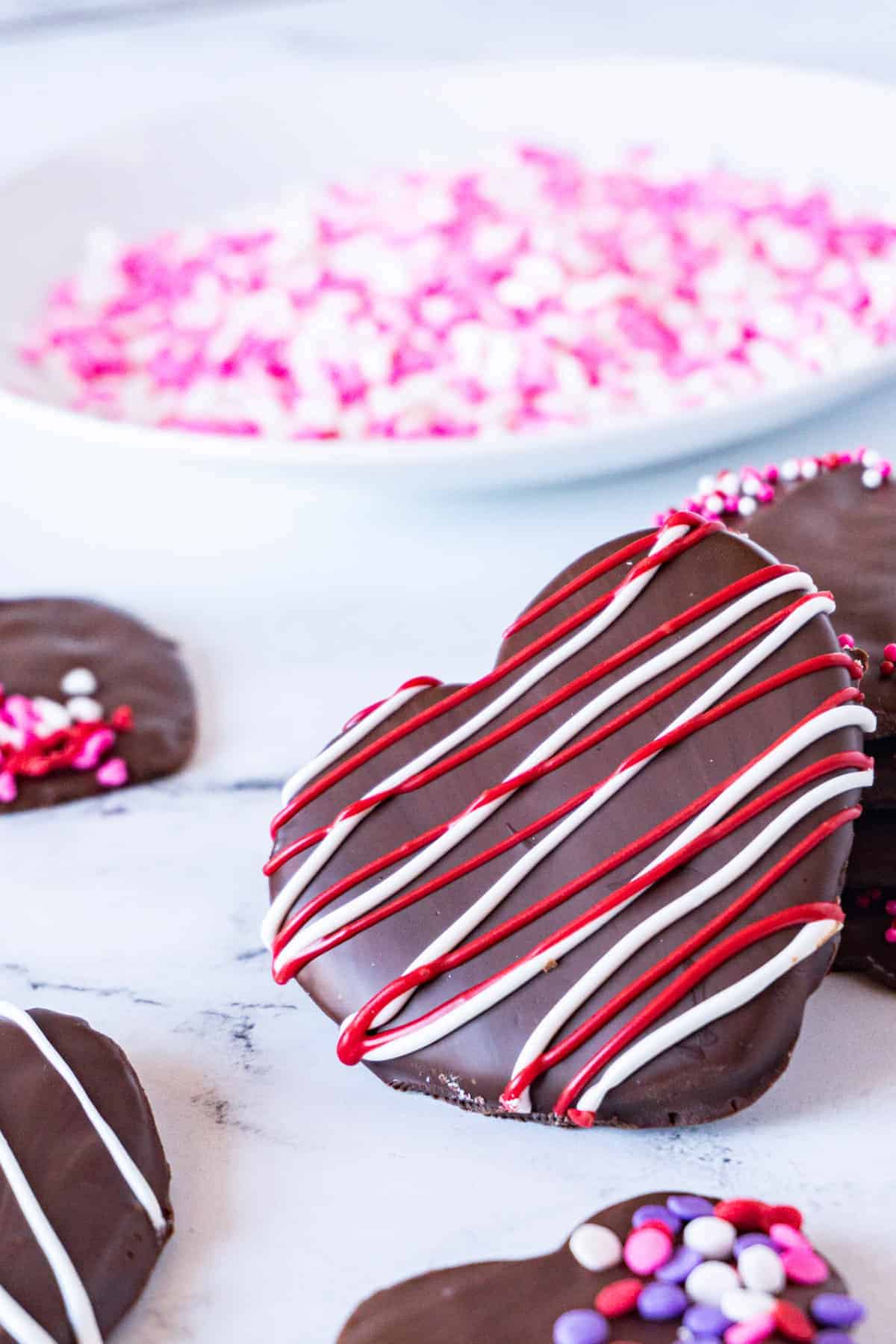 Chocolate Cherry Cookies, perfect for a delicious sweet dessert! Cut into hearts and drizzle with chocolate- for the perfect Valentine’s Day cookie! close up of cookie with strips
