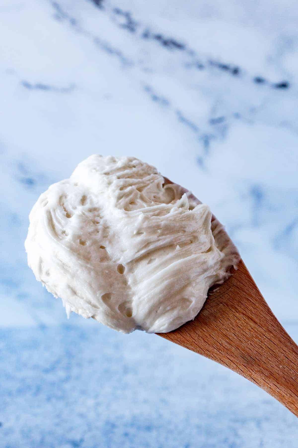 Cream Cheese Frosting on wooden spon