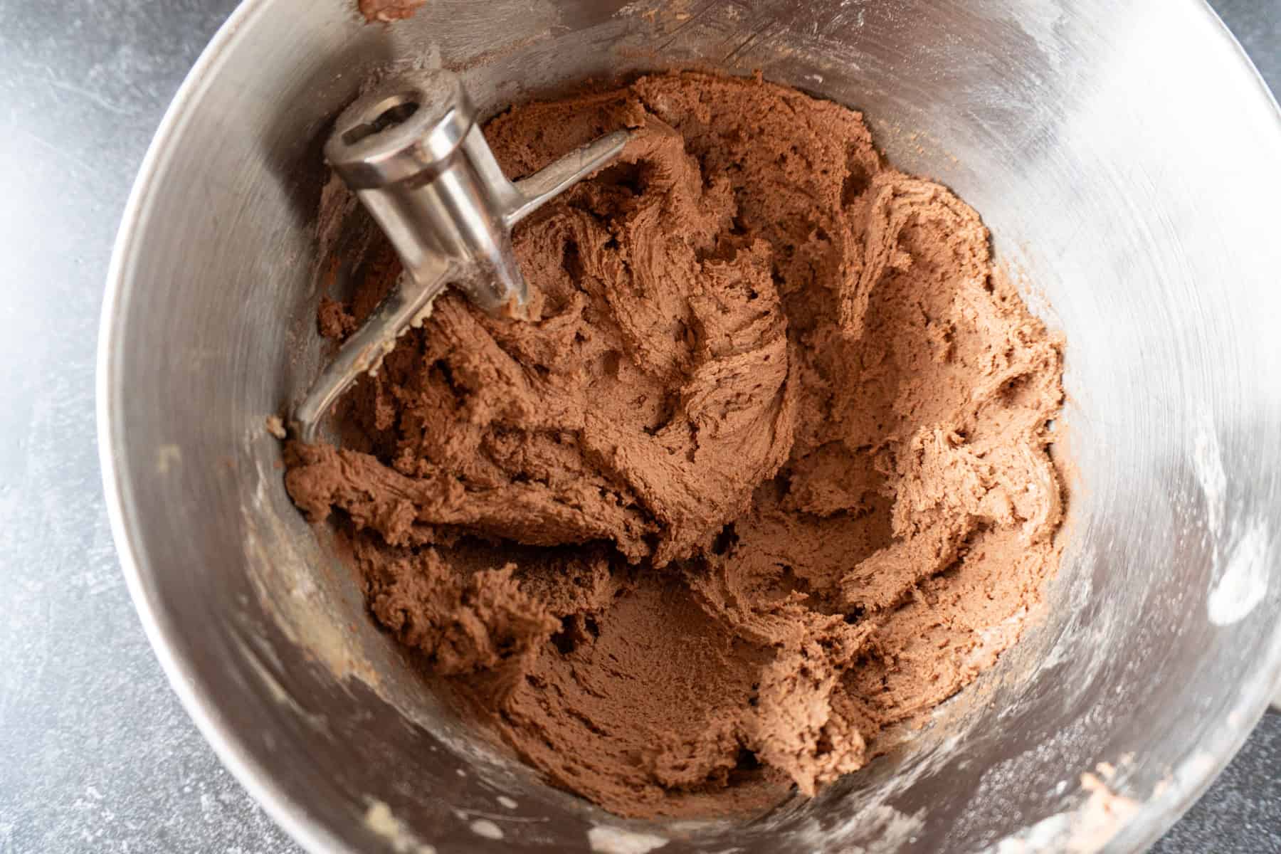 chocolate pudding mix and flour mixed into eggs and butter and sugar mixture, in metal bowl.