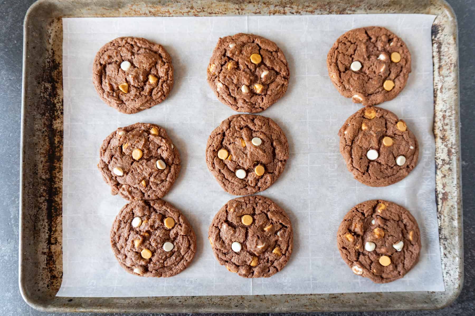 chocolate pudding cookies baked on parchment lined baking sheet.