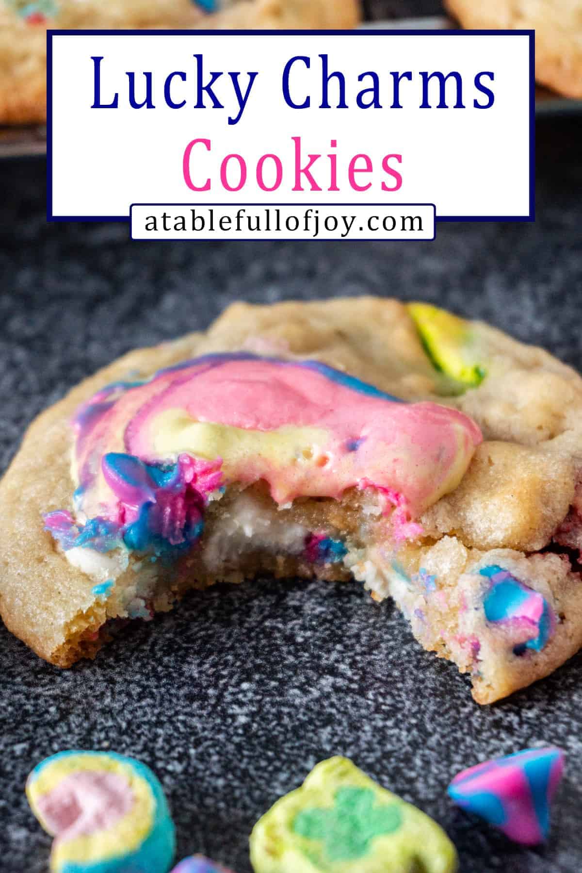 Lucky Charms Cookies are everything magical and super delicious! Filled with cereal bits, crunchy marshmallows, baked to perfection, and topped with gooey marshmallow! #atablefullofjoy #bakery #cookie #chewy #marshmallow #bestcookie #forkids #luckycharms #cereal #rainbow #tiedye #rainbow Lucky Charms Cookies pinterest pin