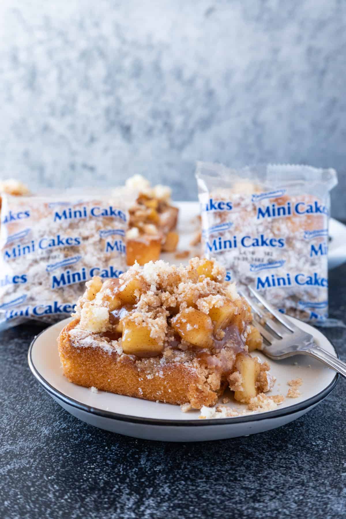 Apple Cobbler Cake next to Crumb Cakes in packages