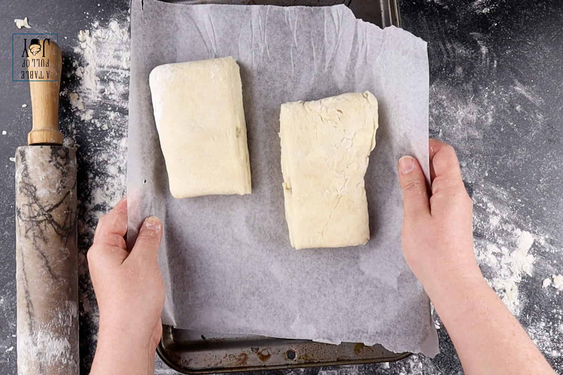 Pie dough folded and cut in half, read to be refrigerated.